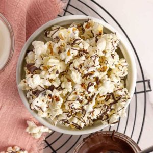 chocolate popcorn in a bowl with pink napkin