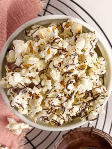 chocolate popcorn in a bowl with pink napkin