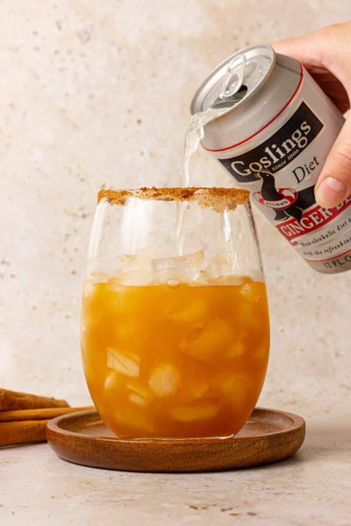 filling glass with ginger beer 