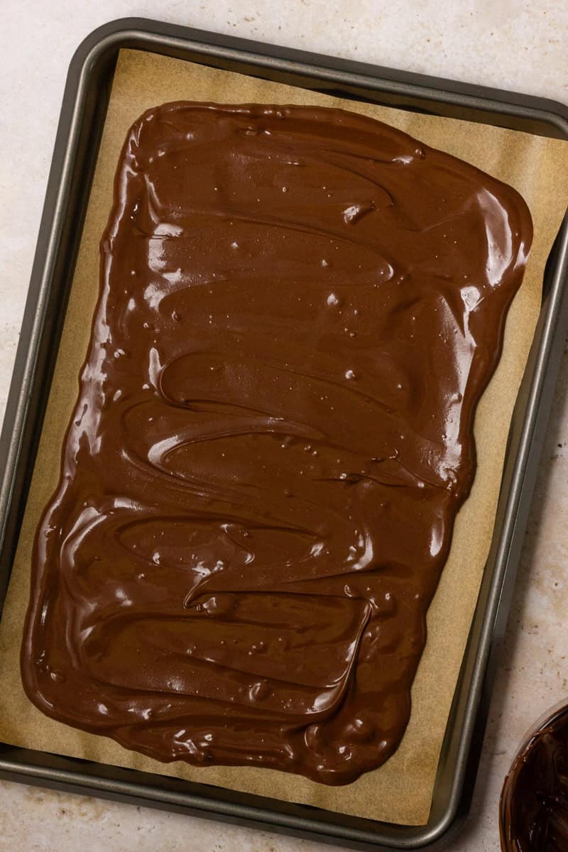 Melted chocolate spread on a parchment paper.