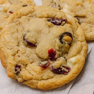 Close-up of Cranberry Orange White Chocolate Cookies with golden edges, dried cranberries, and white chocolate chunks.