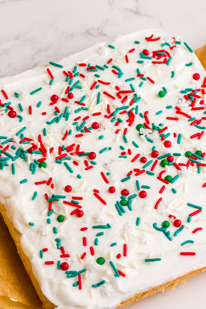 The finished frosted sugar cookie bar is covered with red, green, and white sprinkles.