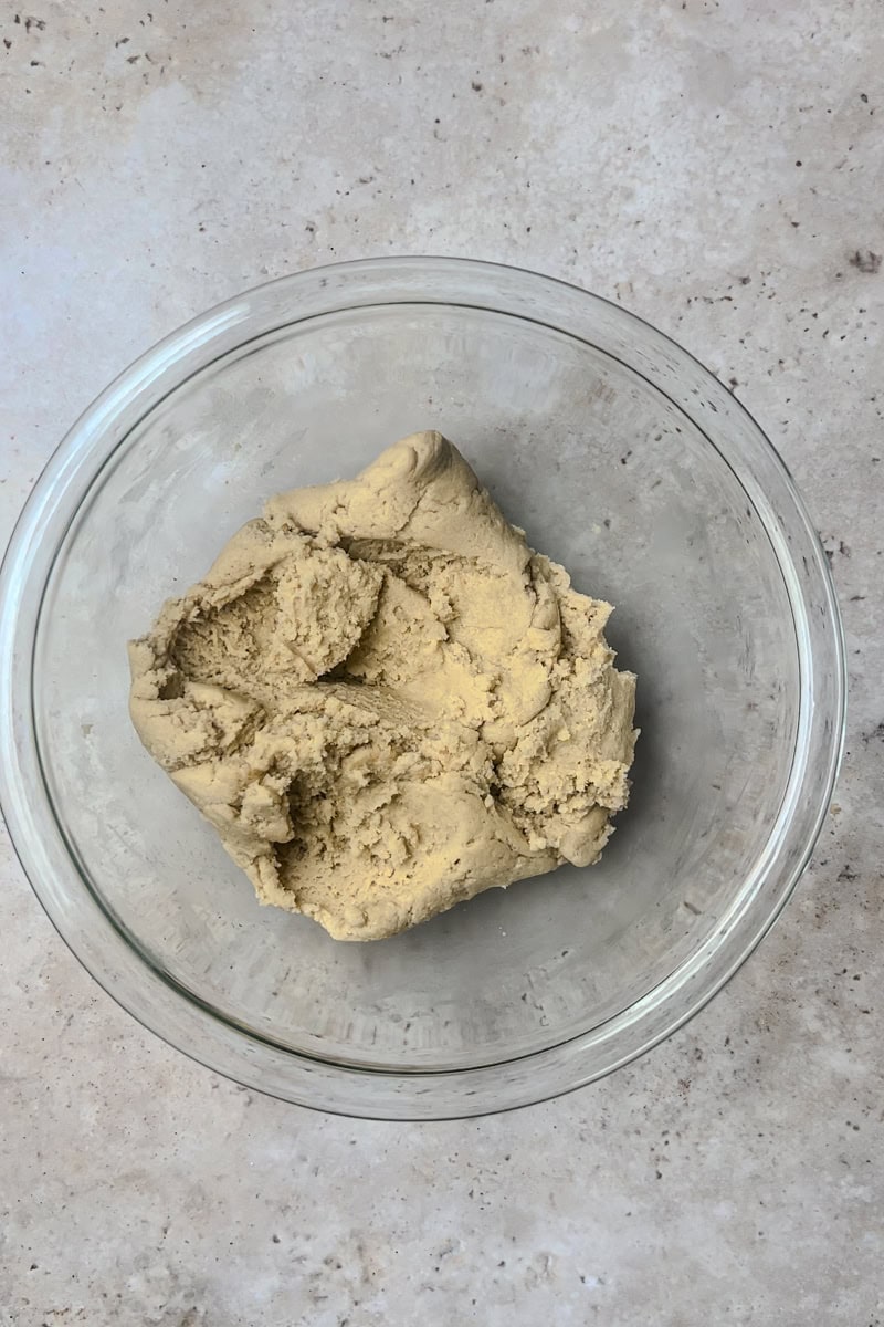 A smooth bowl of cookie dough ready for shaping and baking.