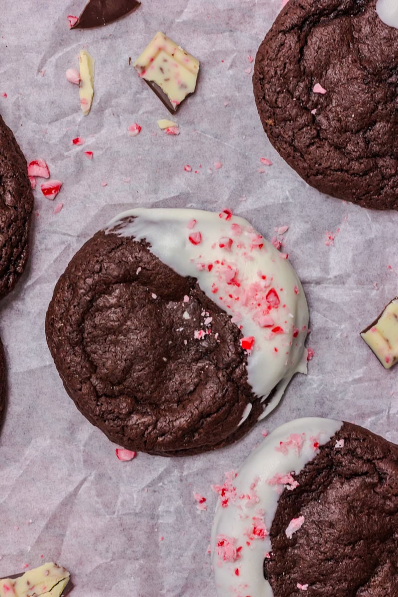 Overhead view of peppermint bark brownie cookies arranged on parchment paper.