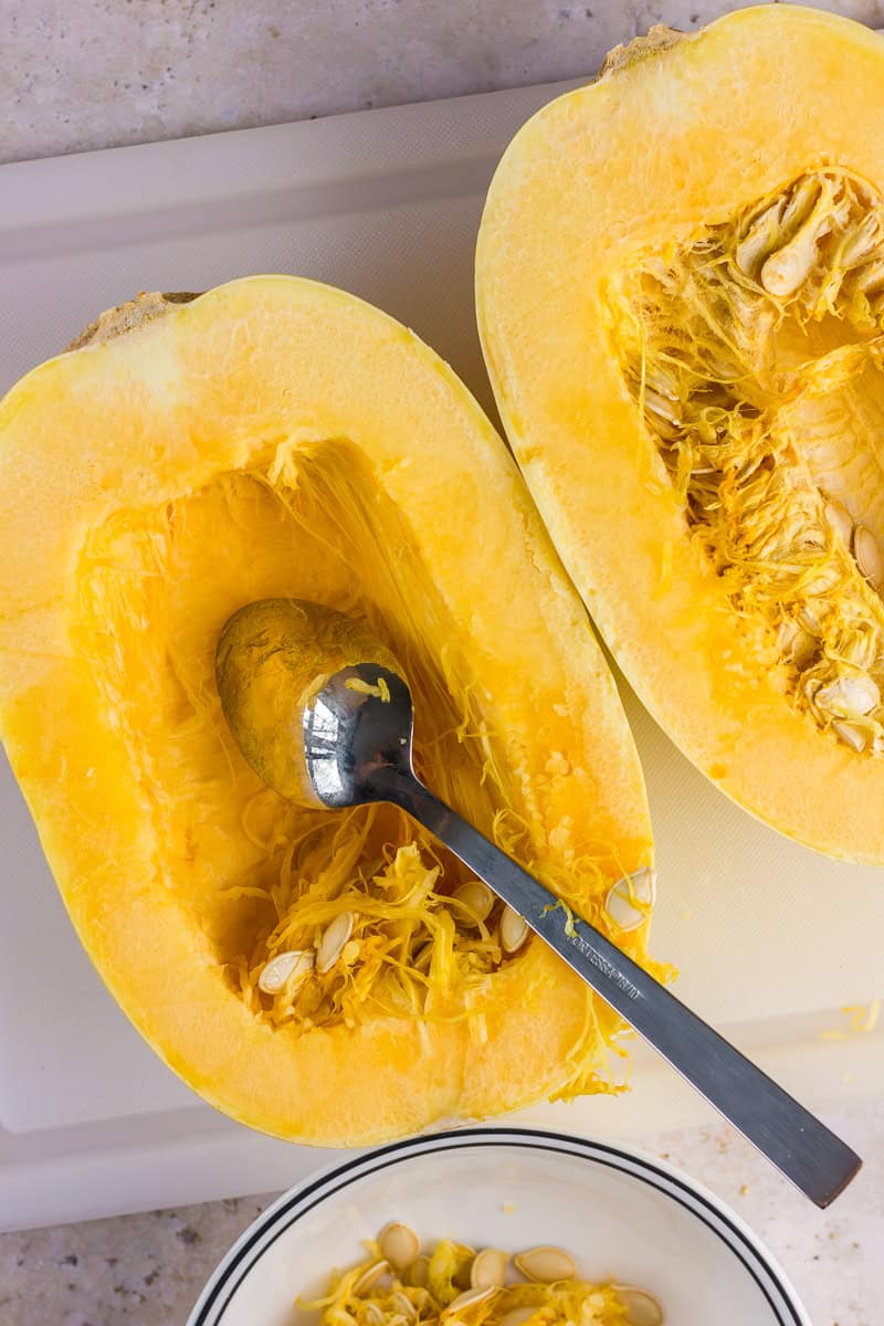 Halved spaghetti squash with seeds removed, ready for baking.