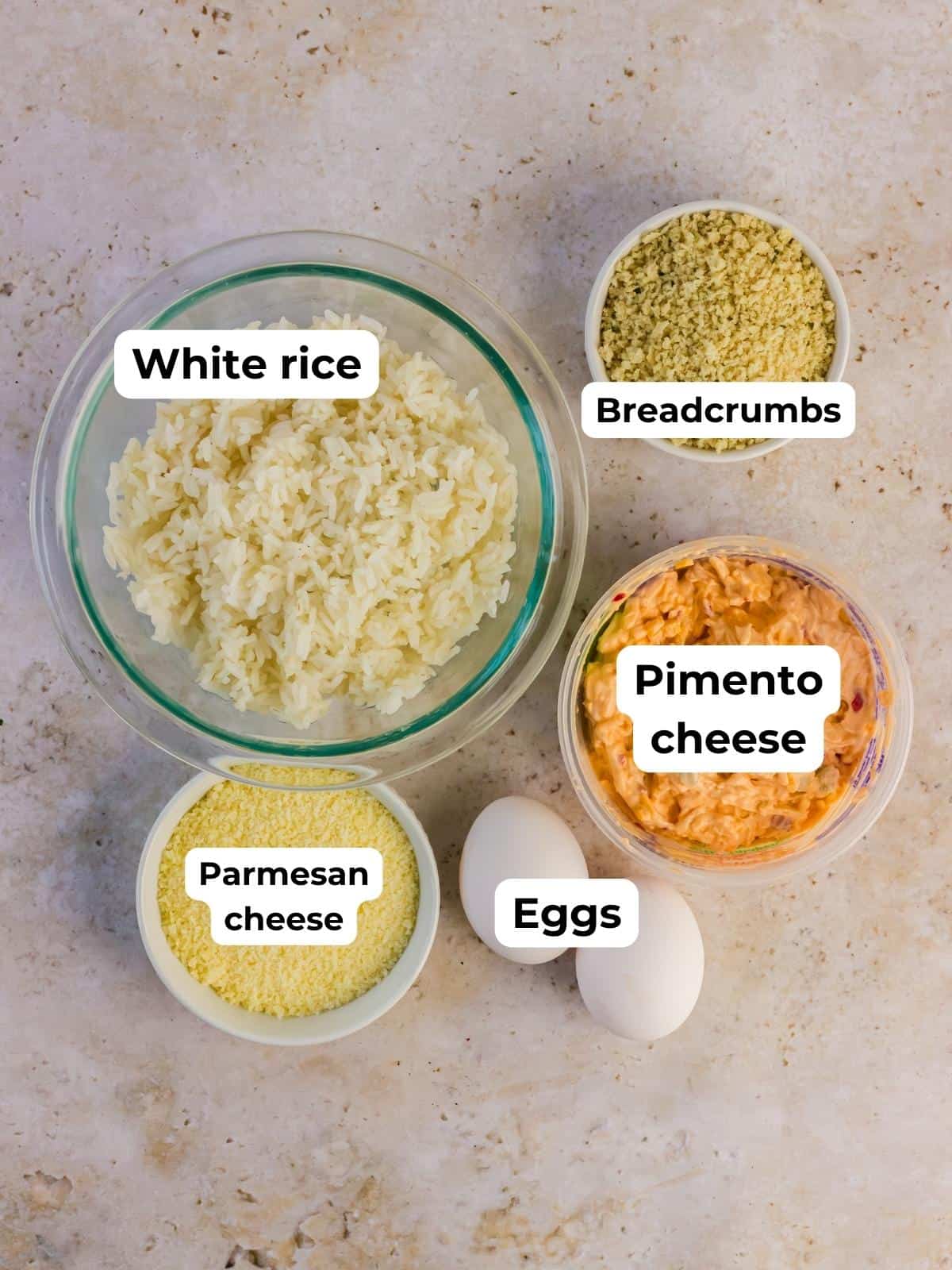 Ingredients for the recipe labeled, including rice, breadcrumbs, eggs, Parmesan cheese, and pimento cheese.