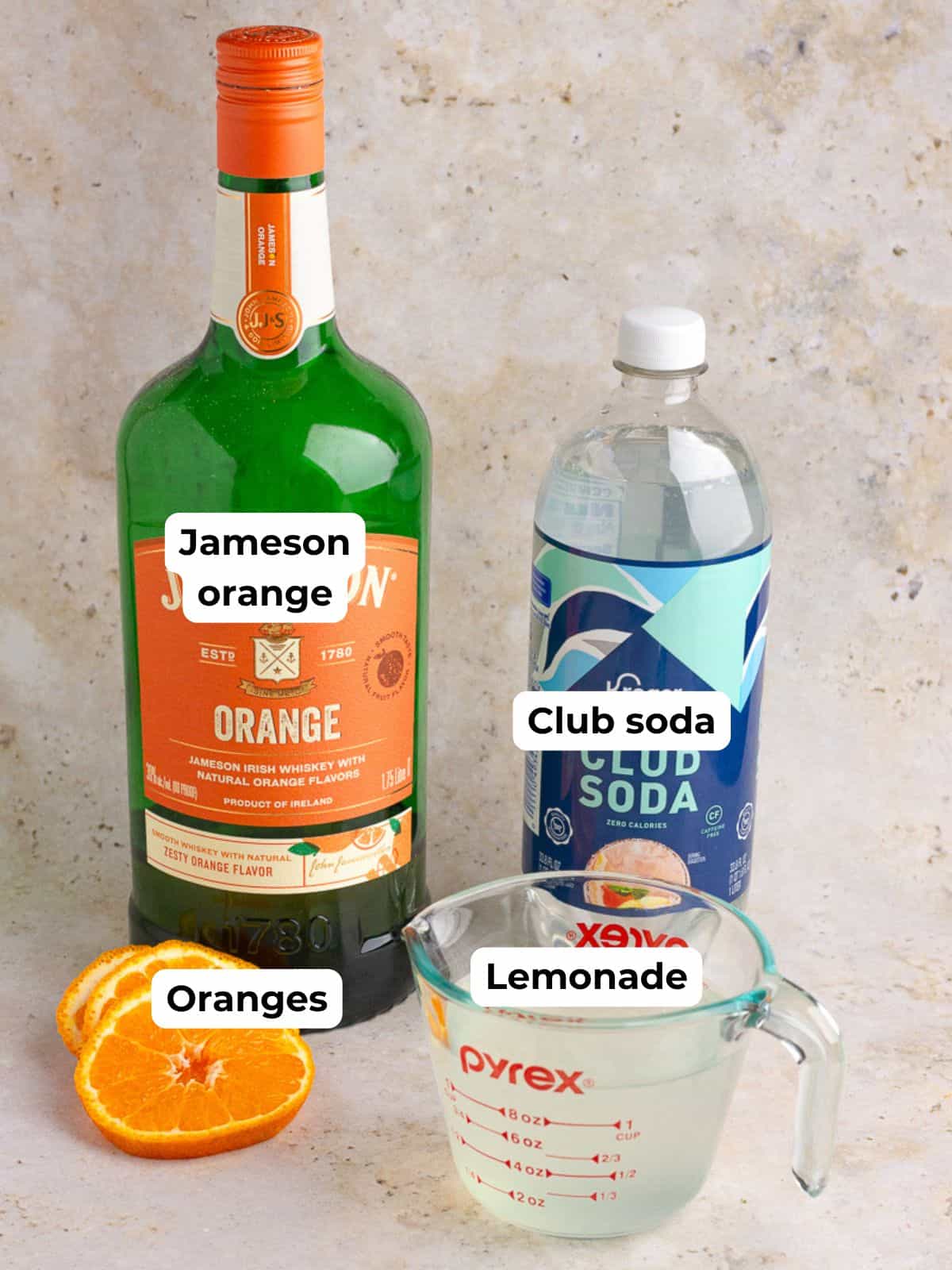 A labeled image displaying Jameson Orange, club soda, lemonade, and fresh oranges as ingredients for the cocktail.