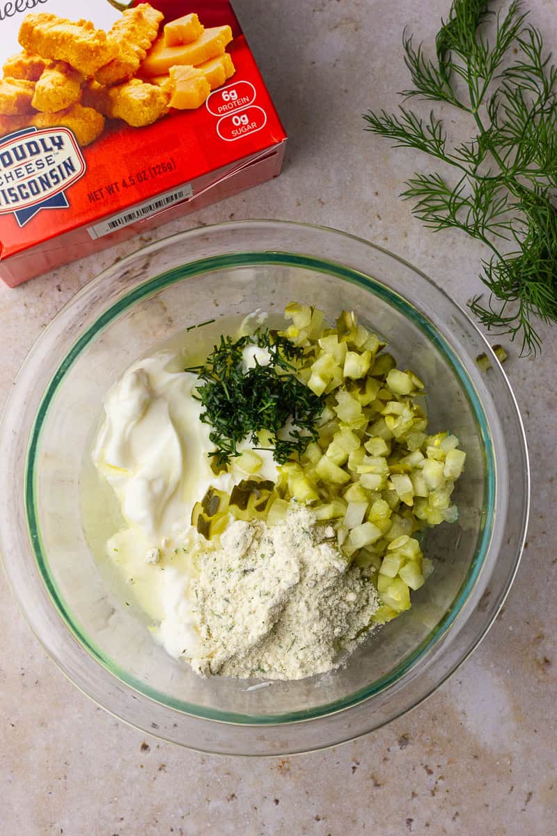 Ingredients for Southern Fried Pickle Dip arranged in a mixing bowl, ready to combine.