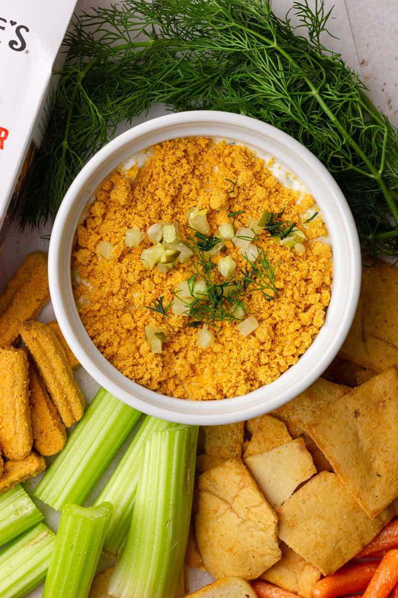 Overhead view of Southern Fried Pickle Dip served with veggies, crackers, and cheese straws.