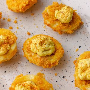 Finished crispy air fryer deviled eggs served on a plate, ready to eat.