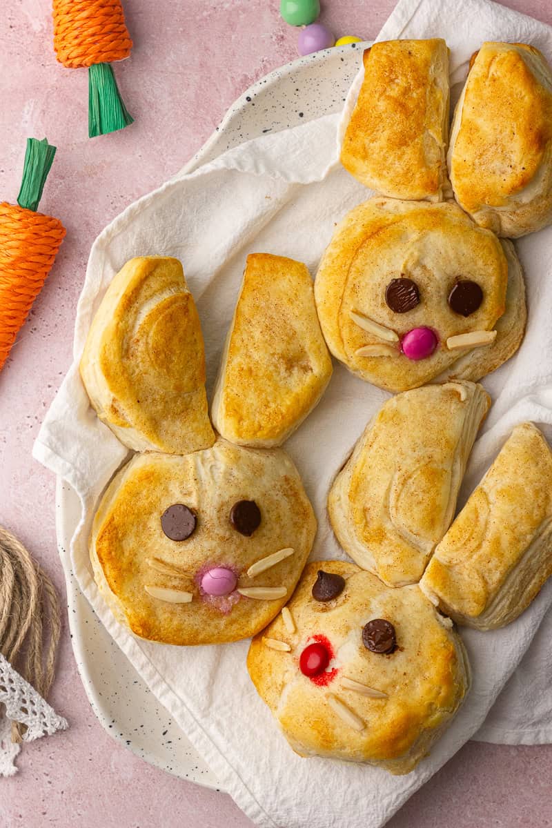 Baked Easter Bunny Biscuits on a speckled plate with napkin and spring decorations.