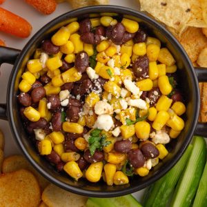 Overhead view of the finished black bean corn feta dip garnished with feta and cilantro.