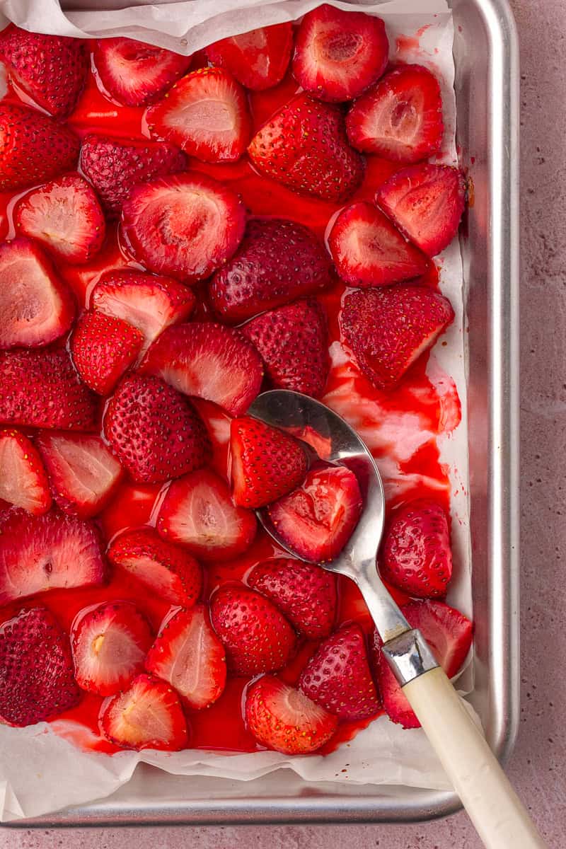 Roasted strawberries are glistening with syrup and ready to be served.
