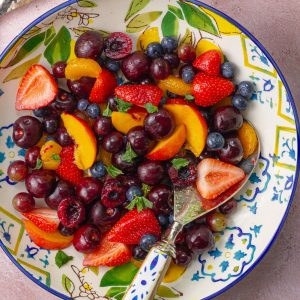 A bright and colorful sangria fruit salad with juicy berries and mint, ready to serve.