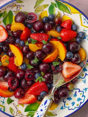 A bright and colorful sangria fruit salad with juicy berries and mint, ready to serve.