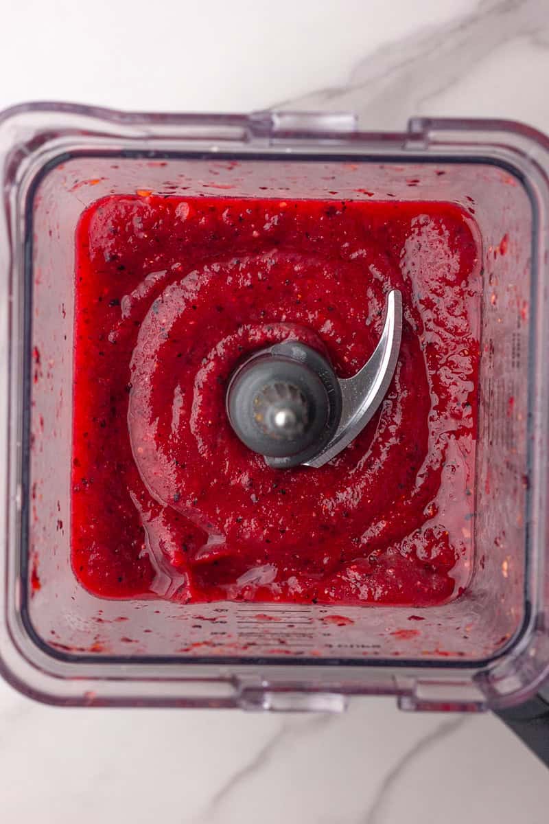 The blended sangria slushie mixture shown in a blender with a smooth, thick texture.