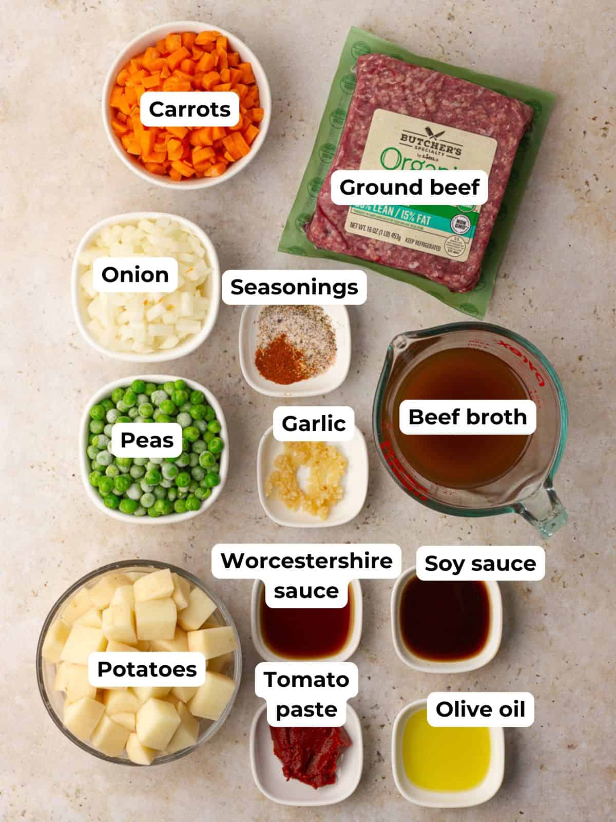 Labeled ingredients for Dutch oven Shepherd’s pie including beef, vegetables, and seasonings.
