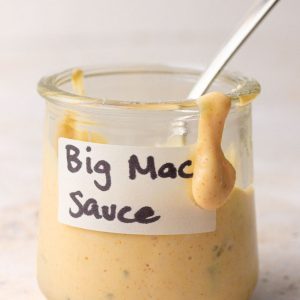 Homemade healthy Big Mac sauce in a jar with a spoon, perfect for dipping fries or topping burgers and salads.