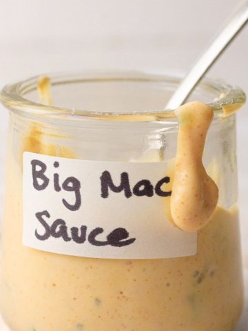 Homemade healthy Big Mac sauce in a jar with a spoon, perfect for dipping fries or topping burgers and salads.