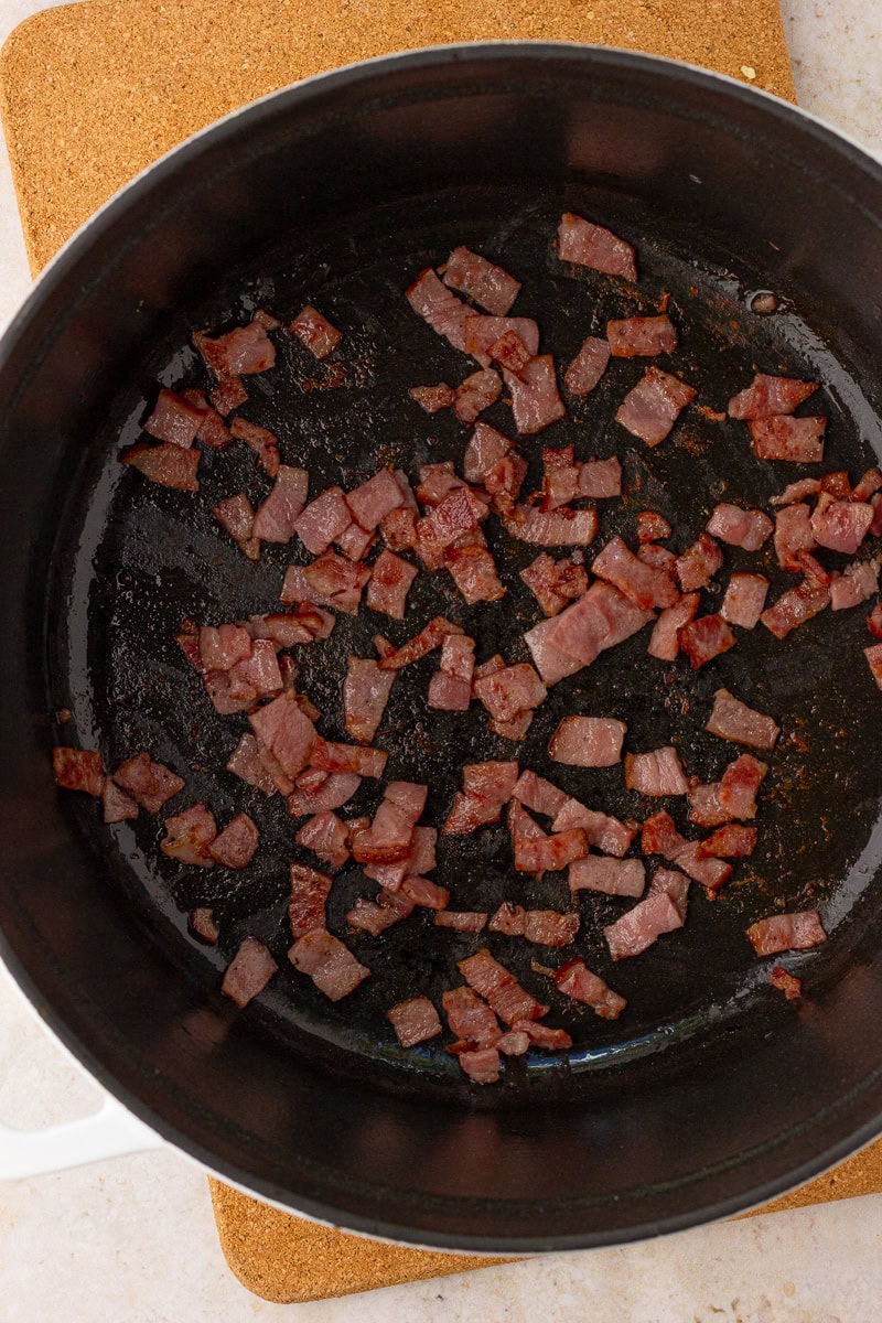Chopped turkey bacon crisps in a Dutch oven to start stovetop low sodium baked beans.