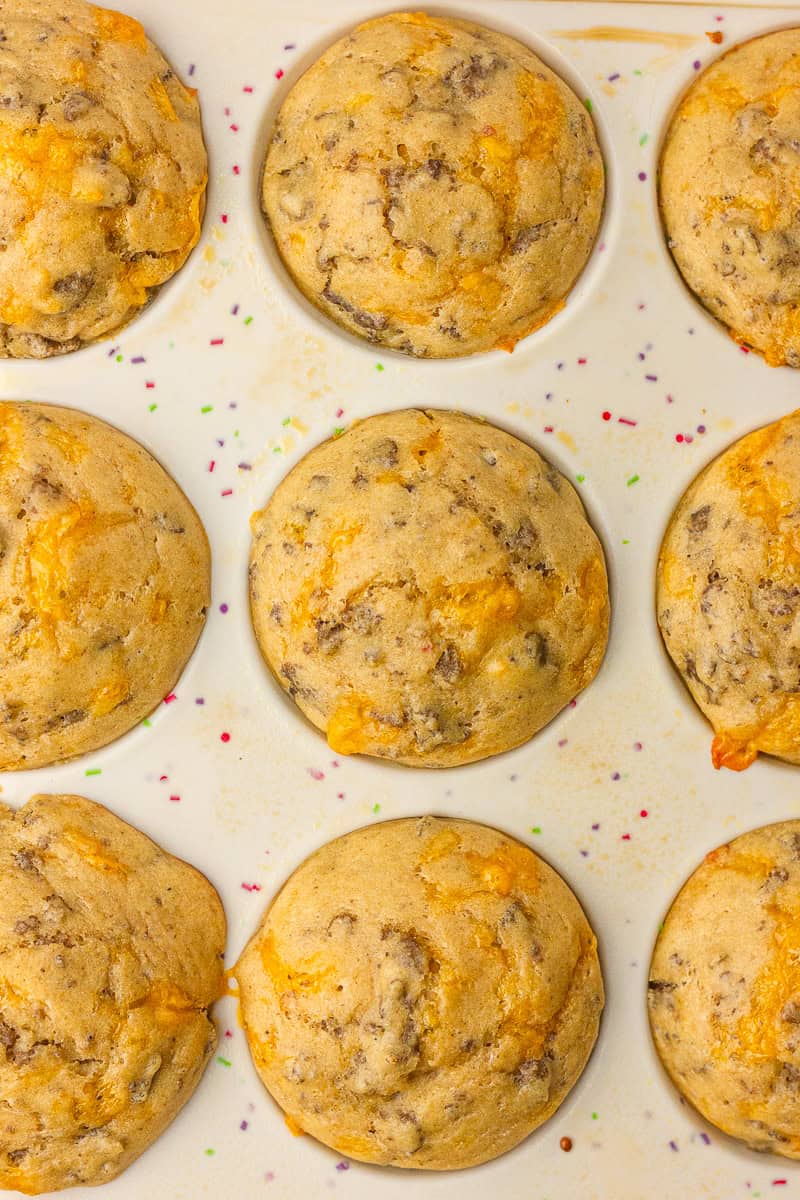 Close up of golden pancake sausage muffins set in a muffin pan.