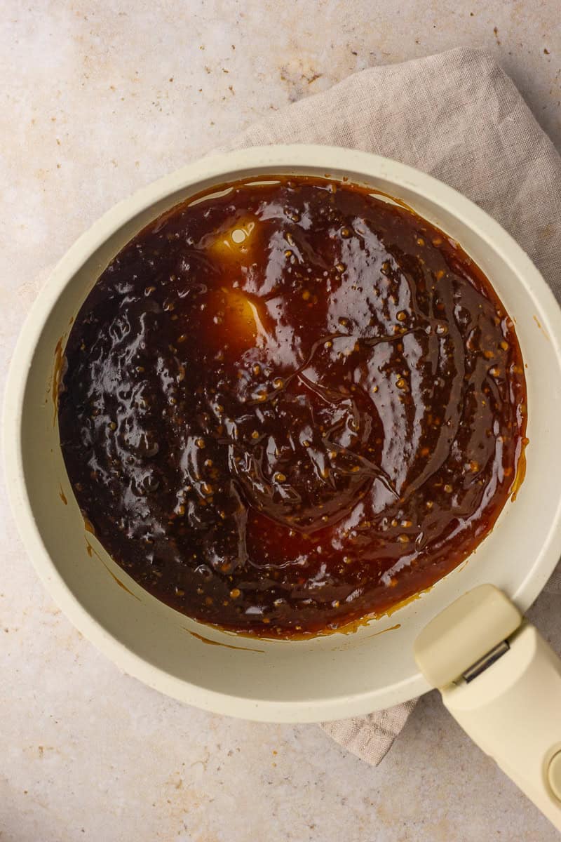Thick, shiny bourbon teriyaki sauce simmers and coats the pan after reducing.