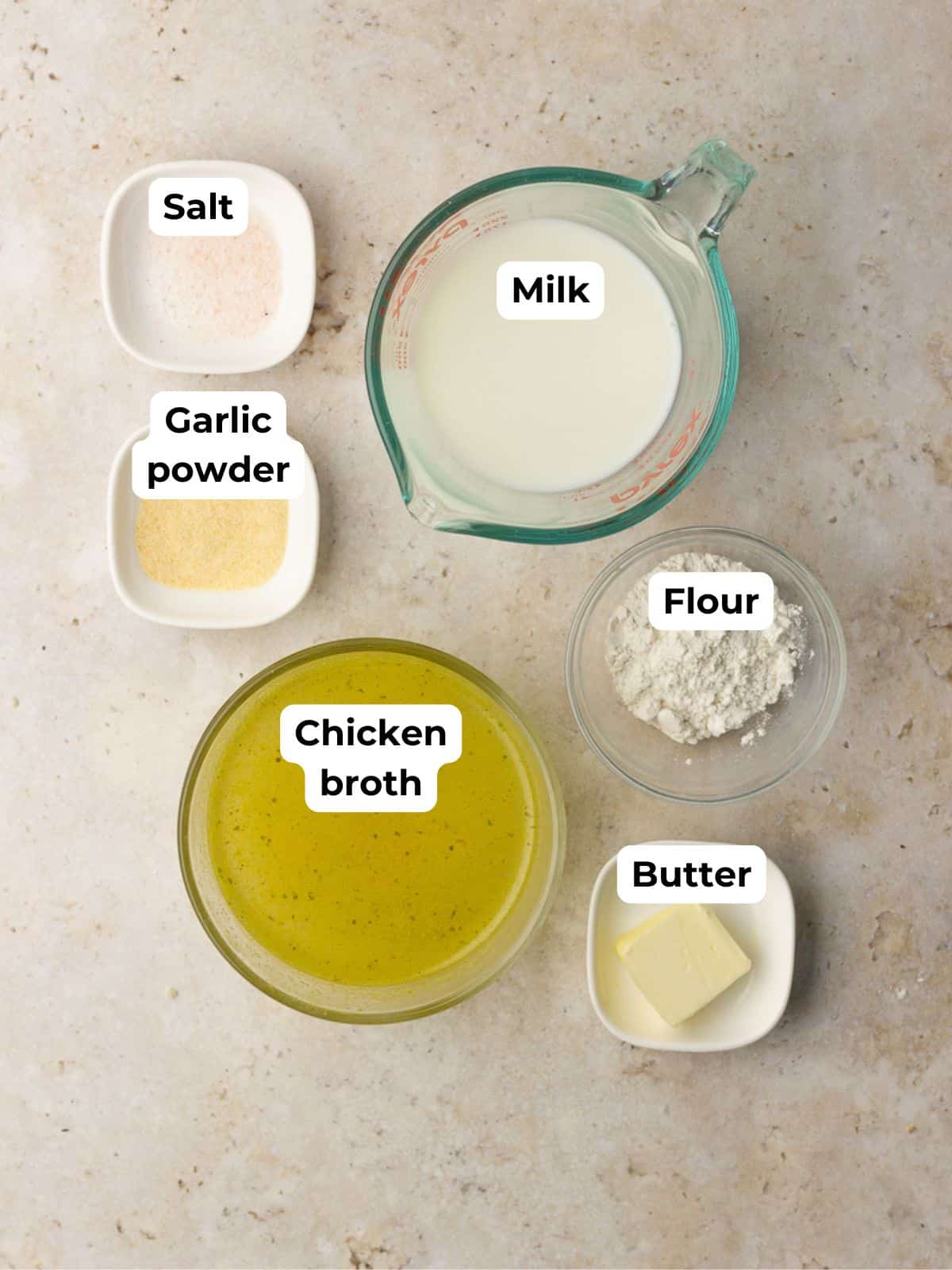 Overhead of cream of chicken soup ingredients arranged on a countertop.