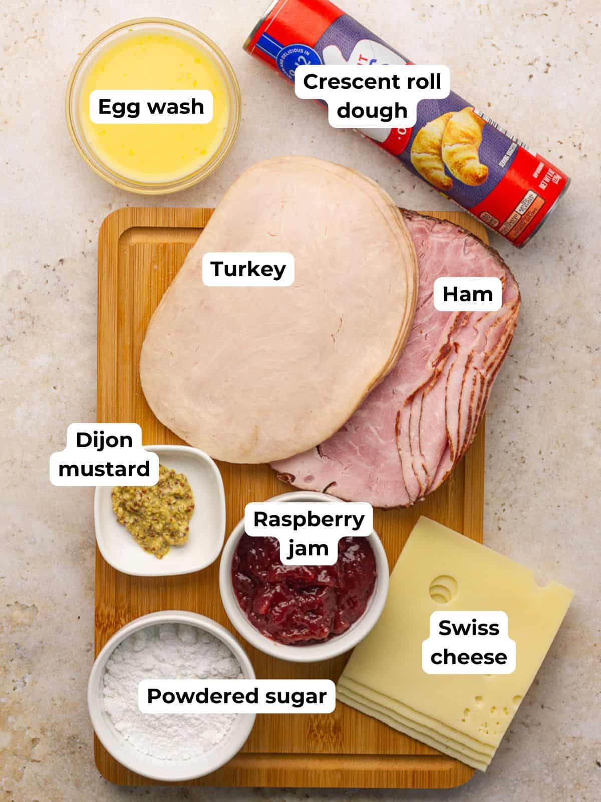 All ingredients for Monte Cristo pinwheels arranged on a board.