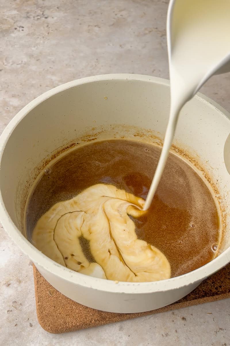 Warm heavy cream is poured into the bubbling caramel to make the sauce smooth and glossy.