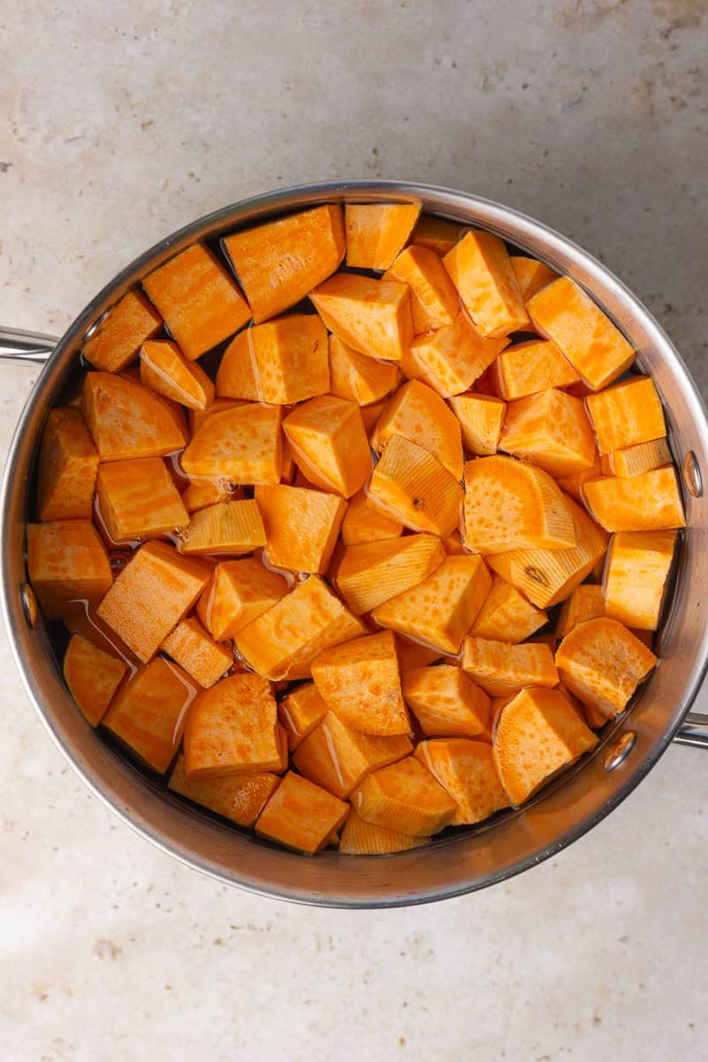 Cubed sweet potatoes in a large pot of water ready to boil.