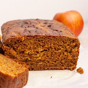 Golden brown apple butter bread sliced open to reveal its moist, spiced crumb.