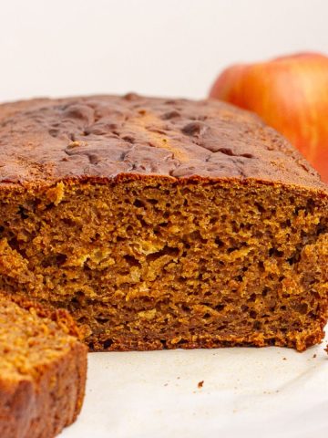 Golden brown apple butter bread sliced open to reveal its moist, spiced crumb.