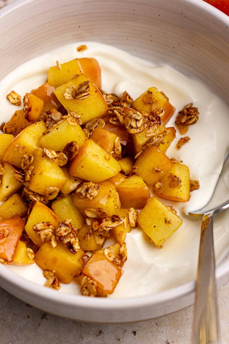 Close-up of the apple pie yogurt bowl showing diced apples coated with oats and cinnamon.
