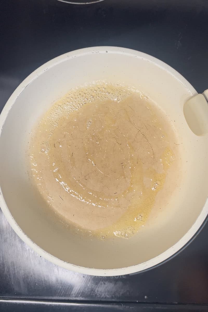 Butter melting in a small skillet to start the apple pie yogurt recipe.