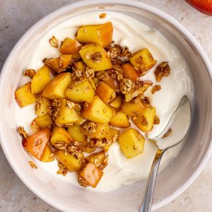 Overhead shot of the finished apple pie yogurt bowl with toasted oats and caramelized apples.