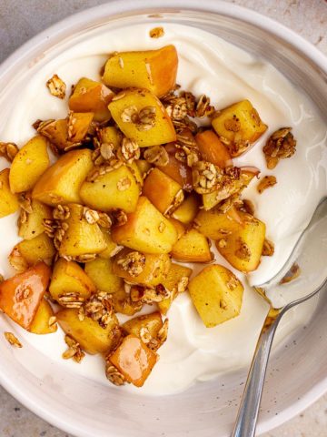 Overhead shot of the finished apple pie yogurt bowl with toasted oats and caramelized apples.