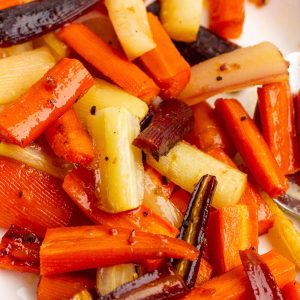 Close-up of roasted rainbow carrots showing caramelized edges and glossy glaze.