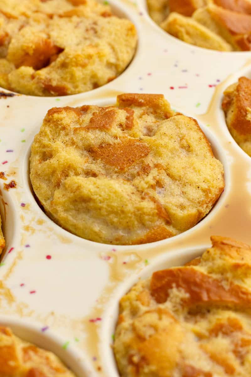 Golden brown french toast cups freshly baked and still sitting in the muffin tin.