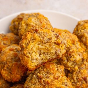 A close-up shot of sausage balls showing their golden, cheesy texture.
