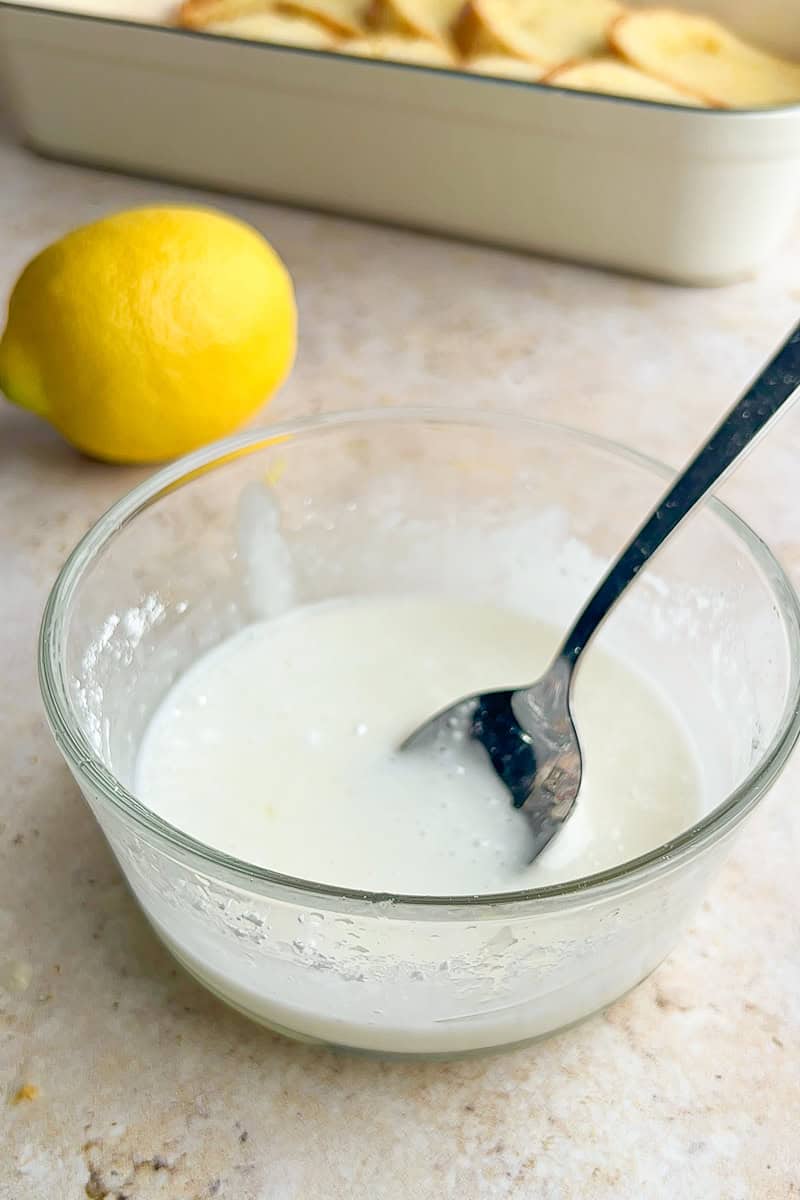 Simple lemon glaze made with powdered sugar and lemon juice in a small bowl.