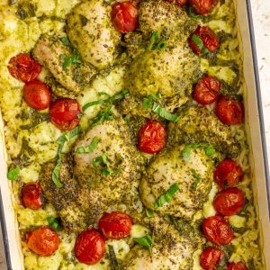 Caprese pesto chicken rice bake with juicy chicken, melted mozzarella, and roasted tomatoes in one dish.