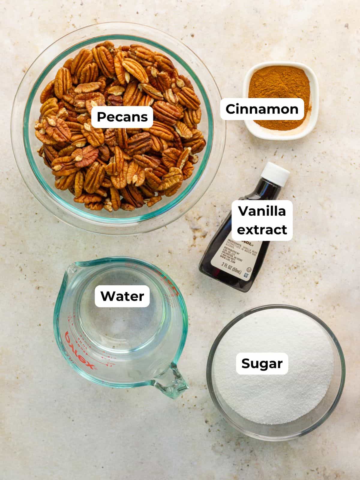 The ingredients for cinnamon pecans are labeled on a countertop.