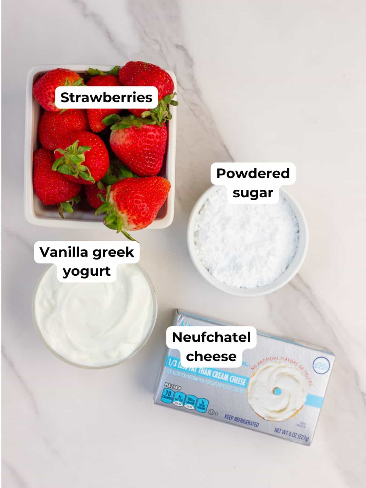 Strawberries, vanilla Greek yogurt, powdered sugar, and Neufchâtel cheese are displayed for deviled strawberries.