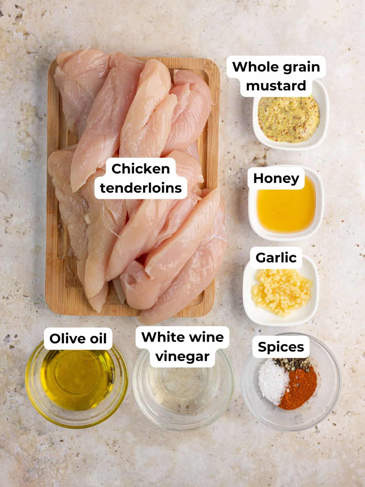 Ingredients for honey mustard chicken tenders are labeled on a countertop.