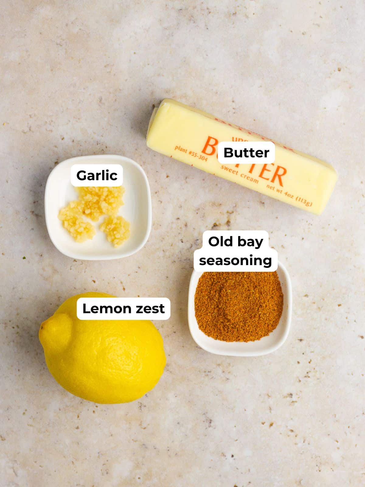 Butter, garlic, Old Bay seasoning, and lemon zest are labeled for making Old Bay butter.
