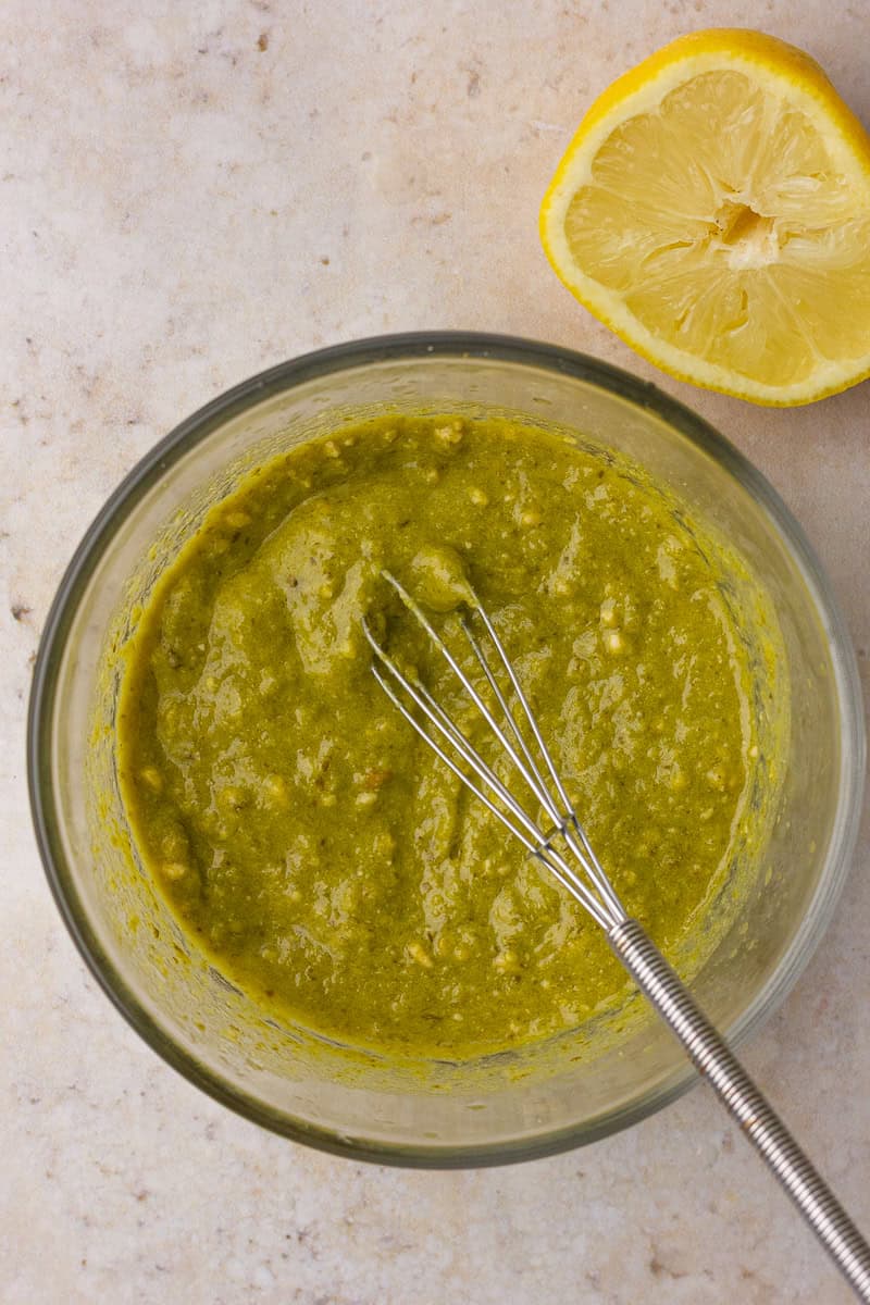Pesto and fresh lemon juice are whisked together in a small bowl for a bright, simple dressing.