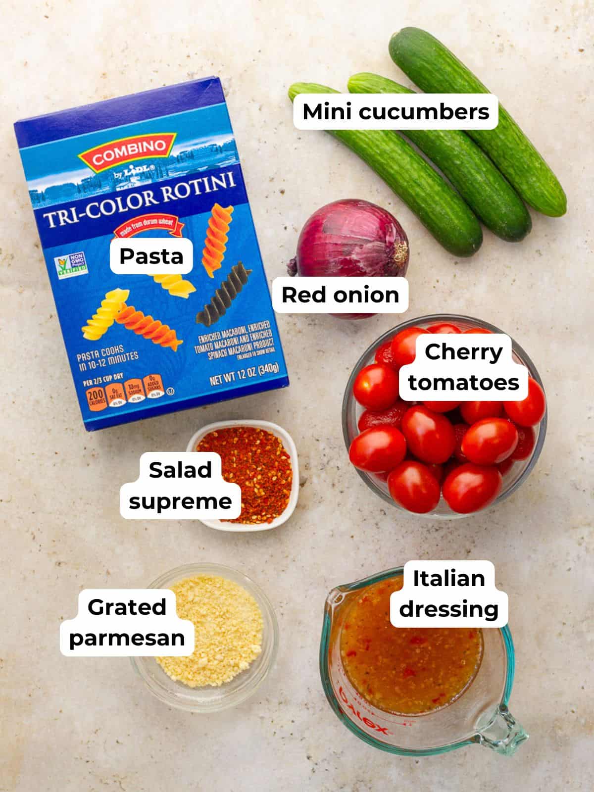 Salad supreme pasta salad ingredients are labeled on a countertop.