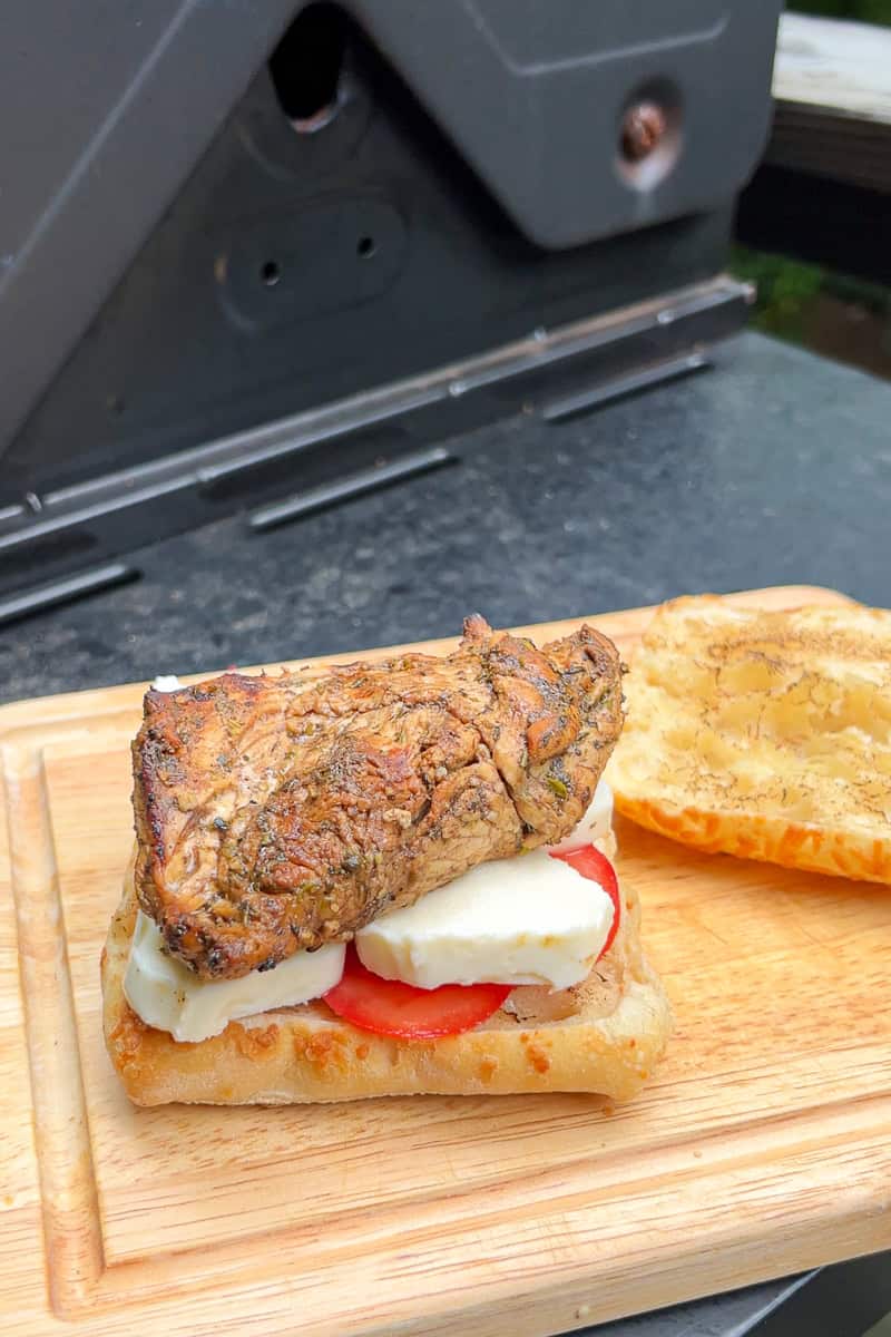 Grilled balsamic chicken, fresh mozzarella, and tomato slices are layered onto toasted ciabatta bread.
