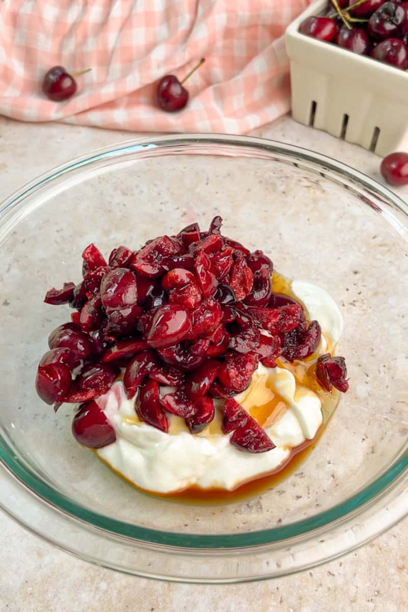 Chopped cherries are added to Greek yogurt with honey and vanilla.