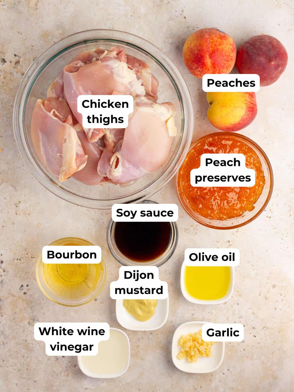 Ingredients for grilled peach chicken are arranged on a countertop with labels.